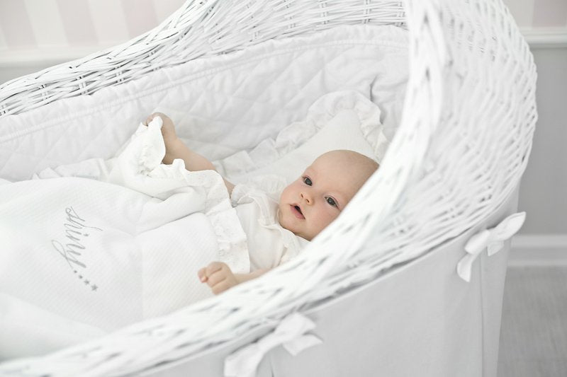 Mobile Wicker Bassinet with Light Pink Skirt